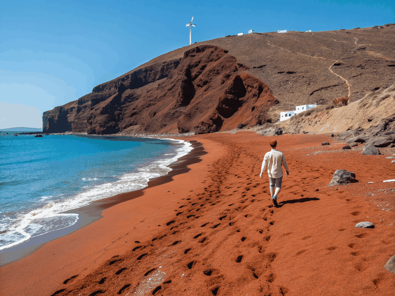 Striking red volcanic cliffs and beach coast in Santorini
